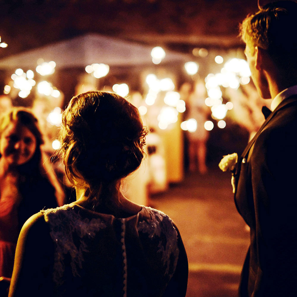 Newlyweds watching a sparkler send-off